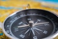 Close up view on compass and map in background Royalty Free Stock Photo