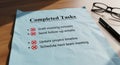 Completed tasks list with checkmarks glasses and pen document organization productivity Royalty Free Stock Photo