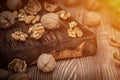 Close up view composition of walnut kernels and whole walnuts on rustic cuting desk. Selective focus. toned Royalty Free Stock Photo