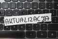 A close-up view of a computer keyboard featuring a handwritten note that reads ACTUALIZATION. This image symbolizes tech Royalty Free Stock Photo
