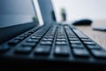 close up view of computer keyboard at table with computer mouse and laptop Royalty Free Stock Photo