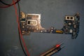 Close up View of a Computer Motherboard on a Workbench With Tools Surrounding It While Repairs Are Taking Place in a Royalty Free Stock Photo
