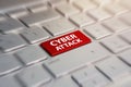 Close-up view on conceptual keyboard Cyber Attack red key on grey silver laptop keyboard. blurred in motion background. Royalty Free Stock Photo