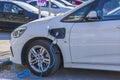 Close up view of connected charging cable to BMW car from an electric vehicle charging station. Sweden