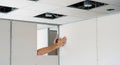 Construction Worker Installing Drywall in an Office Interior with Suspended Ceiling building Royalty Free Stock Photo