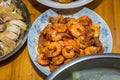 Close-Up View on Cooked Shrimps. Southern Chinese Festivity Rural Food on Bowls and Plates at a Wooden Table