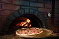 close up view of cooking process of raw pizza on wooden stove Royalty Free Stock Photo