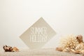 close up view of coral, seashells and card with summer holiday lettering on sand on grey background Royalty Free Stock Photo