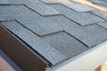 Close up view on corner roof made is asphalt roofing shingles.
