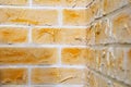 Close up view of corner of wall made of hand made orange gypsum plaster bricks