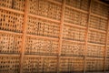 Close up view of countless Japanese symbols on a wooden board..(Kyoto, Japan - 26/07/2017