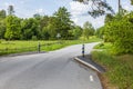 Close-up view of country road with speed limit by compulsion to slow download because of road narrows.