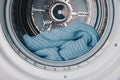 Close-Up View of a Cozy Blue Knitted Blanket Inside a Modern Washing Machine Drum, Highlighting Soft Textures and Efficient Royalty Free Stock Photo