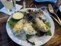 Close up view of crab stuffed prawns on a bed of salad greens inside a steakhouse restaurant