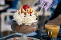 Close-up view of cream topped delicious chocolate muss served with a purple paper horse on a stick