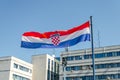 Close Up View of a Croatian Flag Waving Proudly Under the Bright Blue Sky on a Sunny Day in Pula, Croatia. Buildings in Background