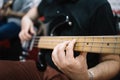 Close-up view of cropped male guitarist playing bass guitar Royalty Free Stock Photo