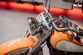 Close up view. Cropped photo of yellow and metallic colored clean motorcycle standing indoors