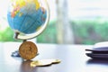 Cryptocurreny Bitcoin Coin Isolated on Table with Miniature Globe and Wallet