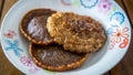 Close up view of Cucur Jawa or Cucur Topi, a traditional Malay food in a white plate