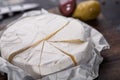 Close up view of cut brie cheese on wooden cutting board Royalty Free Stock Photo