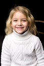 Close Up View of Cute Smiling Blonde Girl Posing on Black Backgr Royalty Free Stock Photo