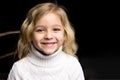 Close Up View of Cute Smiling Blonde Girl Posing on Black Backgr Royalty Free Stock Photo