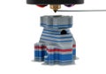 3d printer extruder creating layered multi-colored objects with precision and detail Royalty Free Stock Photo