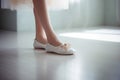 Close-up view of dancing legs of ballerina wearing white pointe ballet shoes in the dancing hall. Generative AI