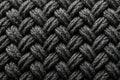 Close-up view of dark grey knitted wool, showcasing intricate texture and repeating pattern, ideal for backgrounds or design Royalty Free Stock Photo
