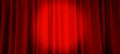 close up view of dark red curtain in thin and thick vertical folds made of black out sackcloth fabric, panoramic view. Royalty Free Stock Photo
