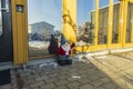 Close up view of decorative Christmas cute gnome figure standing near an entrance door. Christmas Holiday Concept. Postcard.