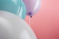 Close up view of decorative colorful balloons on pink background. Royalty Free Stock Photo