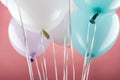 Close up view of decorative colorful festive balloons on pink background. Royalty Free Stock Photo