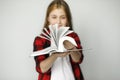 Close up view of defocused open book, on blurred background girl holding book Royalty Free Stock Photo