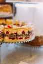 Close-up view of the delicious cake with cherries on the stand. Royalty Free Stock Photo