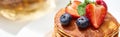 Close up view of delicious pancakes with honey, blueberries and strawberries, panoramic shot Royalty Free Stock Photo