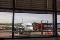 Close-up of view of Delta Airlines plane connected to boarding bridge at Swedish airport before passengers board.