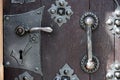 Close up view on detail of a old massive wooden door with metal shackles Royalty Free Stock Photo