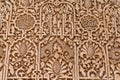 Close up view of detailed carving and Arabic calligraphy work in the Alhambra