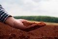 Close-up view, the dirty hands holding dry soil showcase the tactile connection between human and earth. Royalty Free Stock Photo