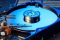 Close-up view of Disassembled Hard Drive illuminated by blue light. Selective focus Royalty Free Stock Photo