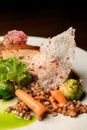 Close-up view on dish of appetizing piece of baked meat with buckwheat and vegetables on plate