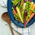 Close up view of a dish of rainbow baby carrots, peas and pea pods. Royalty Free Stock Photo