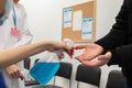 Close-up view of disinfecting the male hands of patients entering a clinic, performed by medical staff in the face of a Royalty Free Stock Photo