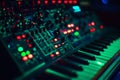 A close-up view displays green illuminated circuitry alongside keyboard components highlighting technology at work Royalty Free Stock Photo