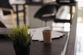 Close up view of disposable coffee cup on wooden desk Royalty Free Stock Photo