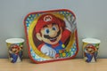 Close-up view of disposable tableware with Mario theme.