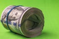 Close up view of 100 dollar bills rolled into roll isolated on chrome key background. Royalty Free Stock Photo