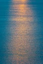 A dramatic orange sun way of reflections in deep blue water Royalty Free Stock Photo